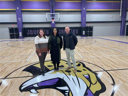 Trava Stewart, Tabitha Owens and Gerald Franks in gym next to Jaguar seal 